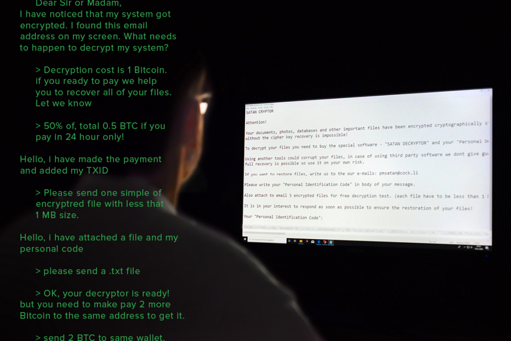 Mann liest im Dunkeln eine Hacker-Botschaft auf seinem PC