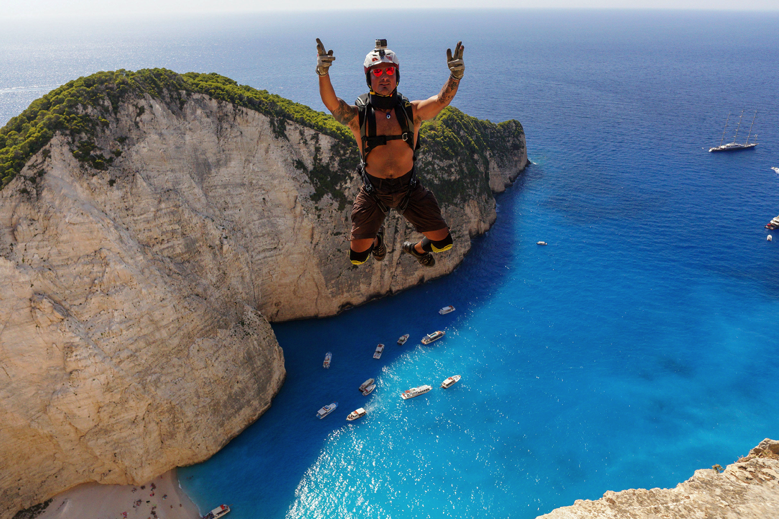 Ein Basejumper ist im freien Fall über der blauen Bucht von Zakynthos.